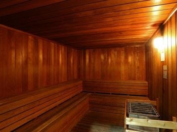 A sauna in a wooden room with a bench